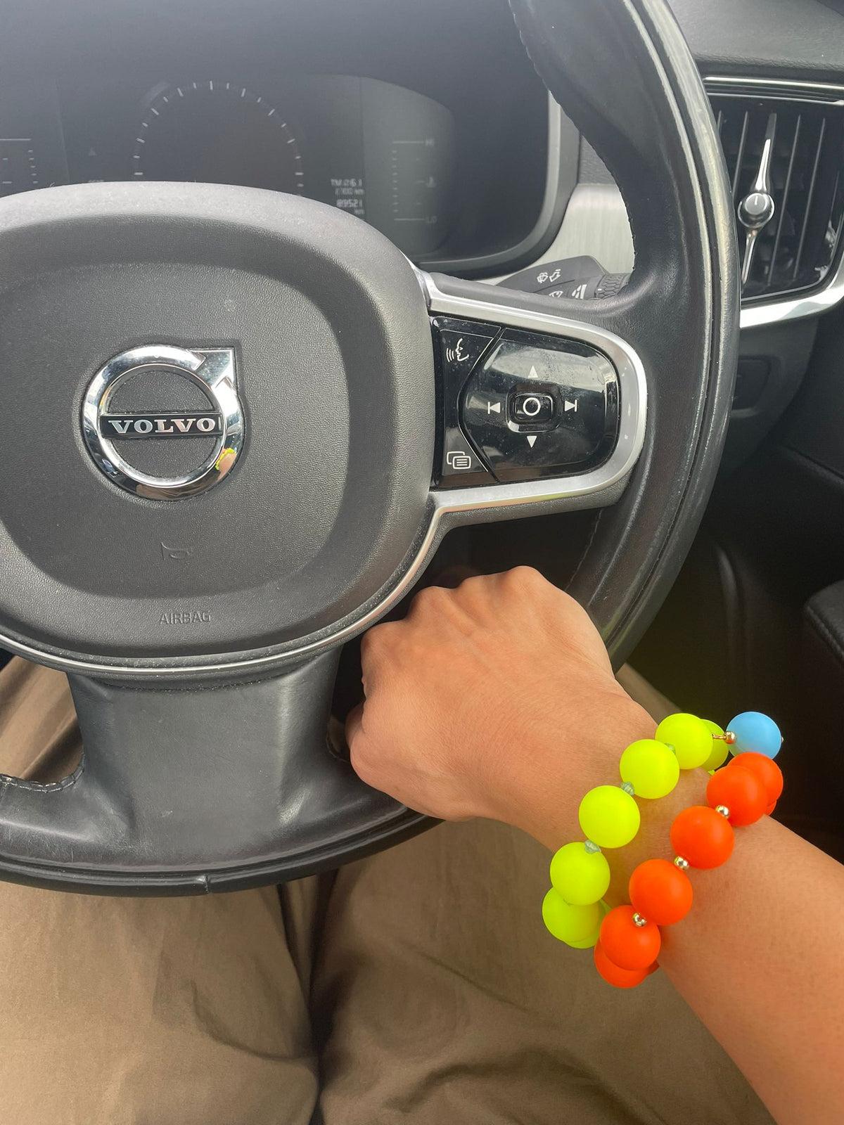 Orange beaded bracelet with gold drop