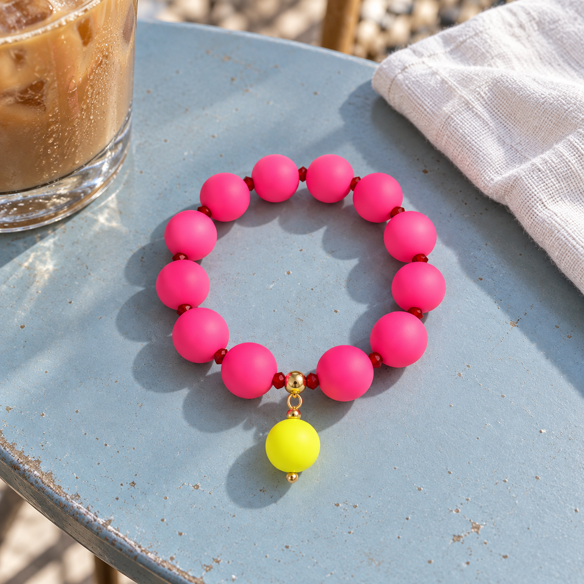 Bright pink silicone beaded bracelet with a neon drop bead