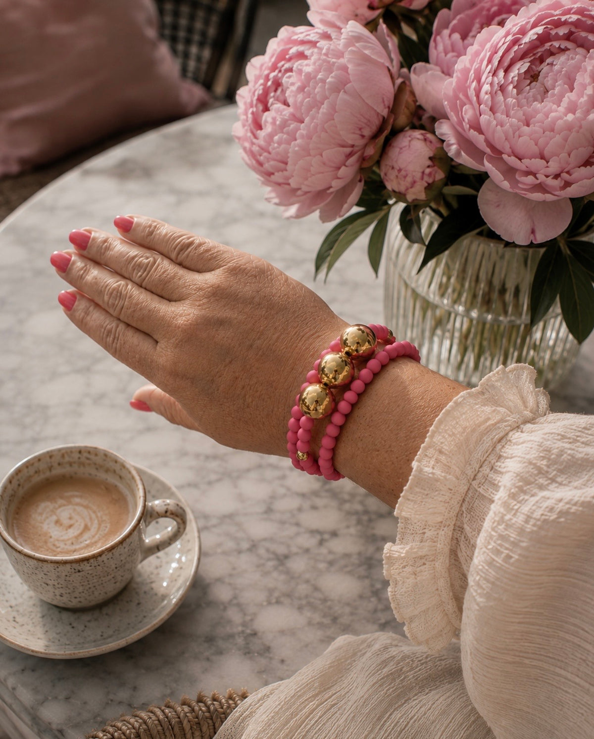 The pink and gold beaded bracelet stack