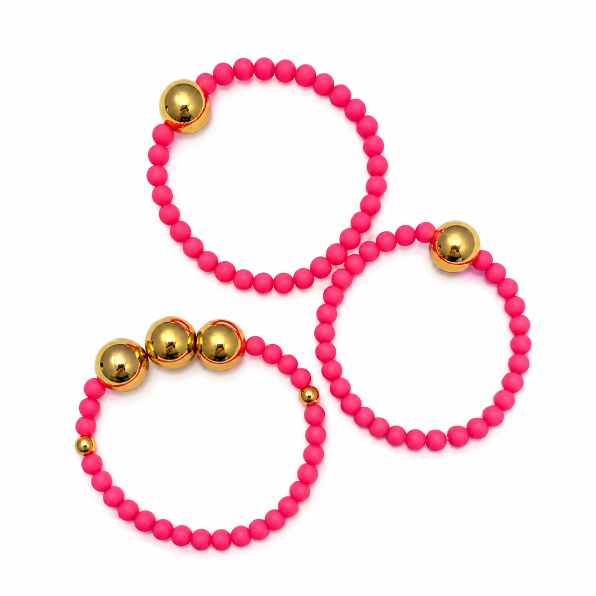 The pink and gold beaded bracelet stack