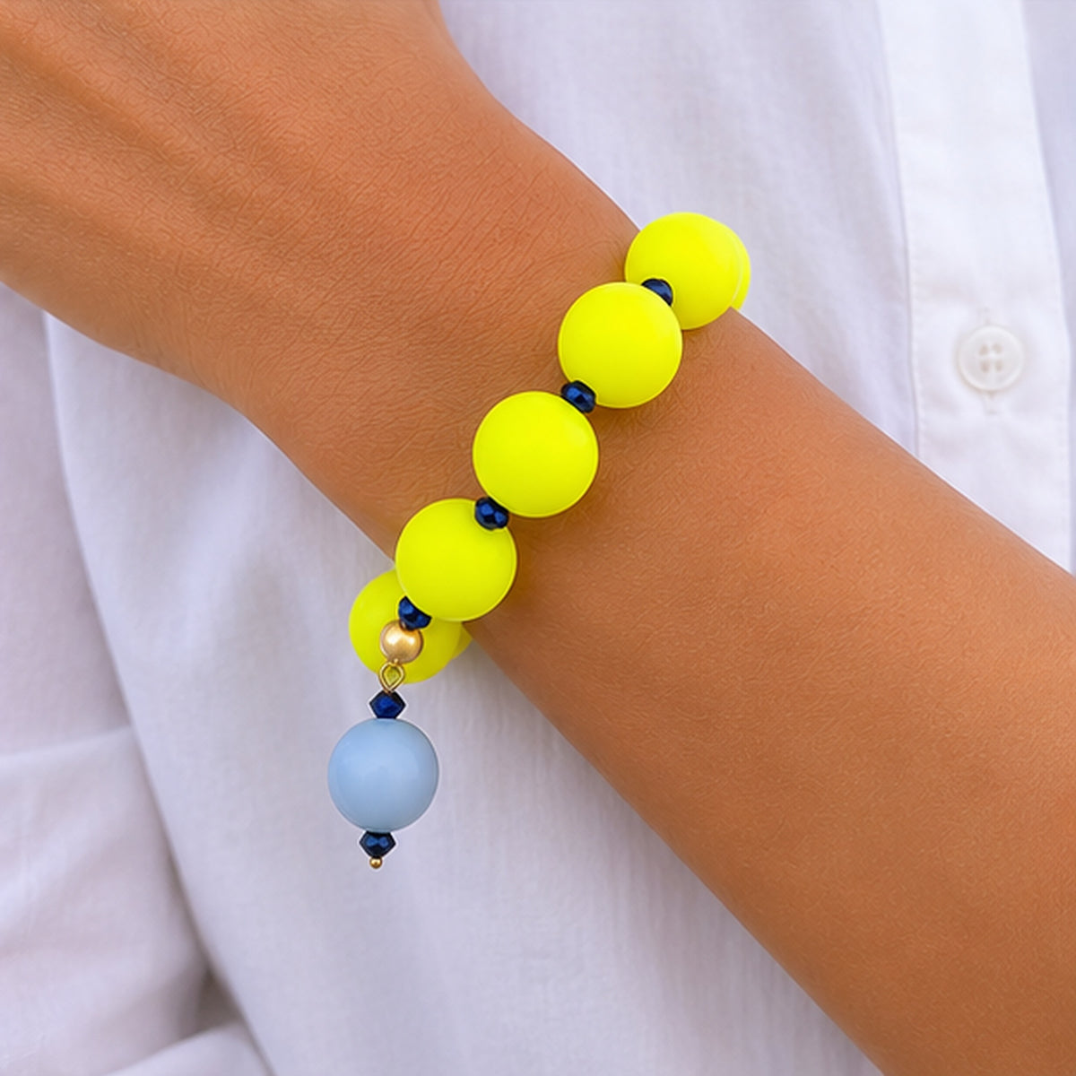 Neon silicone beaded bracelet with blue beaded drop