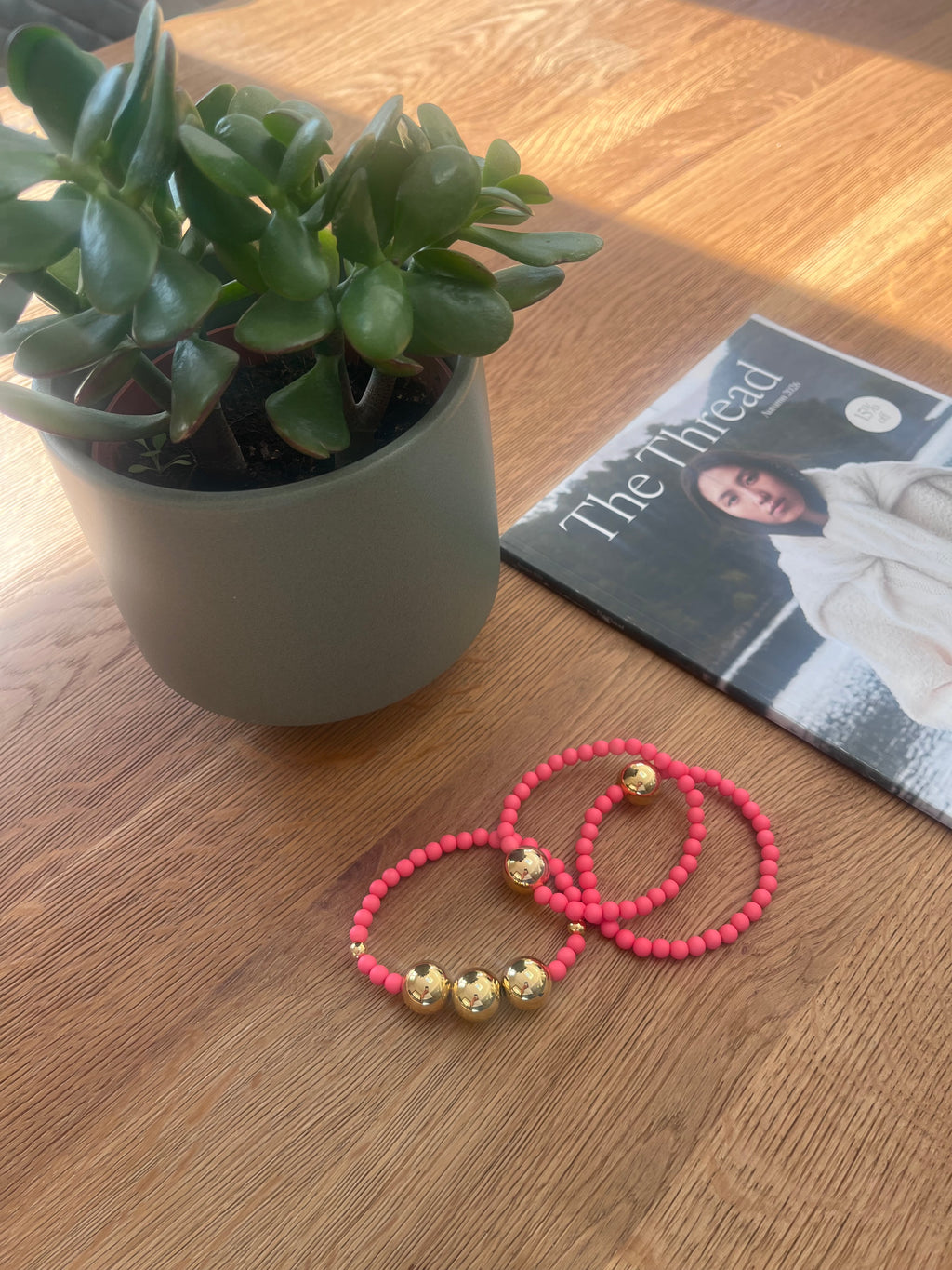 The pink and gold beaded bracelet stack